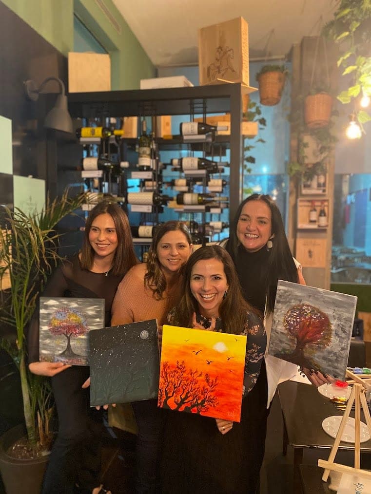 Four friends with their finished tree paintings