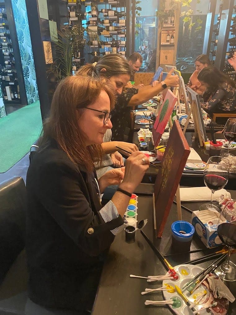 A guest concentrating on her canvas