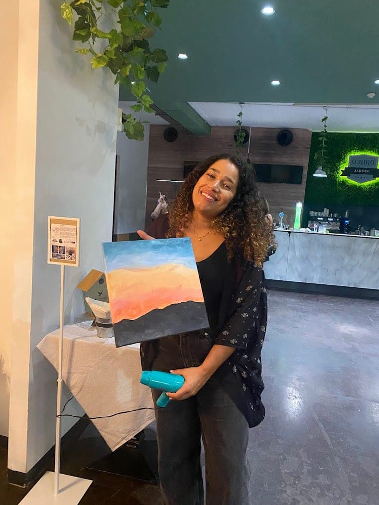 A guest with her finished sunset painting